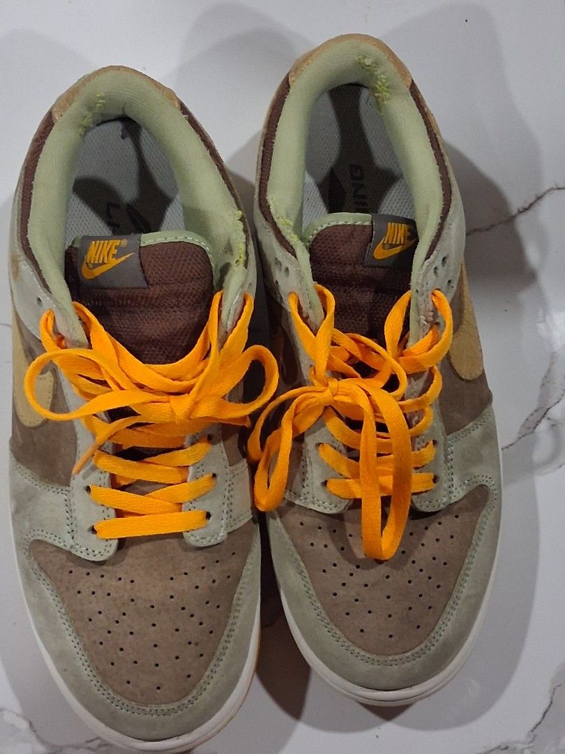 Nike Dunk Low Dusty Olive Size 9.5 (Category: Sneakers) located in San Jose del Monte. Submitted by thrasher80s (Listing ID 1470369298, Image 1). Description: - Model: Nike Dunk Low Medium Curry (Tag: DH5360-300) - Size: US 9.5 / UK 8.5 / EUR 43 - Materials: Premium suede upper in rich brown, olive green, and yellow tones - Details: Eye-catching bright orange laces and matching rubber outsole - Condition: Clean midsoles with very light, minimal w