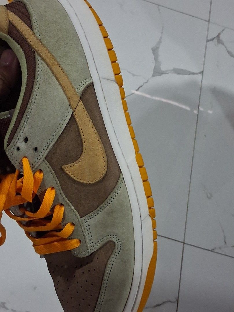Nike Dunk Low Dusty Olive Size 9.5 (Category: Sneakers) located in San Jose del Monte. Submitted by thrasher80s (Listing ID 1470369298, Image 2). Description: - Model: Nike Dunk Low Medium Curry (Tag: DH5360-300) - Size: US 9.5 / UK 8.5 / EUR 43 - Materials: Premium suede upper in rich brown, olive green, and yellow tones - Details: Eye-catching bright orange laces and matching rubber outsole - Condition: Clean midsoles with very light, minimal w