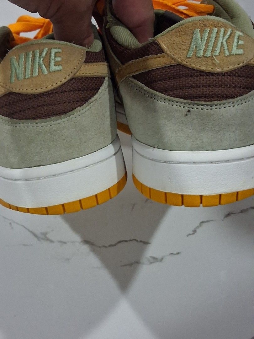 Nike Dunk Low Dusty Olive Size 9.5 (Category: Sneakers) located in San Jose del Monte. Submitted by thrasher80s (Listing ID 1470369298, Image 3). Description: - Model: Nike Dunk Low Medium Curry (Tag: DH5360-300) - Size: US 9.5 / UK 8.5 / EUR 43 - Materials: Premium suede upper in rich brown, olive green, and yellow tones - Details: Eye-catching bright orange laces and matching rubber outsole - Condition: Clean midsoles with very light, minimal w