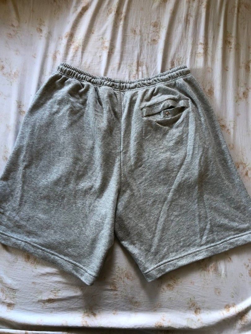 Nike french terry shorts (Category: Shorts) located in Romblon. Submitted by teppthrift. (Listing ID 1470422498, Image 2). Description: - Brand: Nike - Model: FQ4093-063 - Size: XXL - Color: Grey - Material: 80% cotton, 20% polyester fleece - Details: Thick embroidered Nike lettering on the left leg, elastic waistband with adjustable drawstrings - Pockets: Convenient side pockets plus one back pocket with a button closure - Fit: Relaxed fit, supe