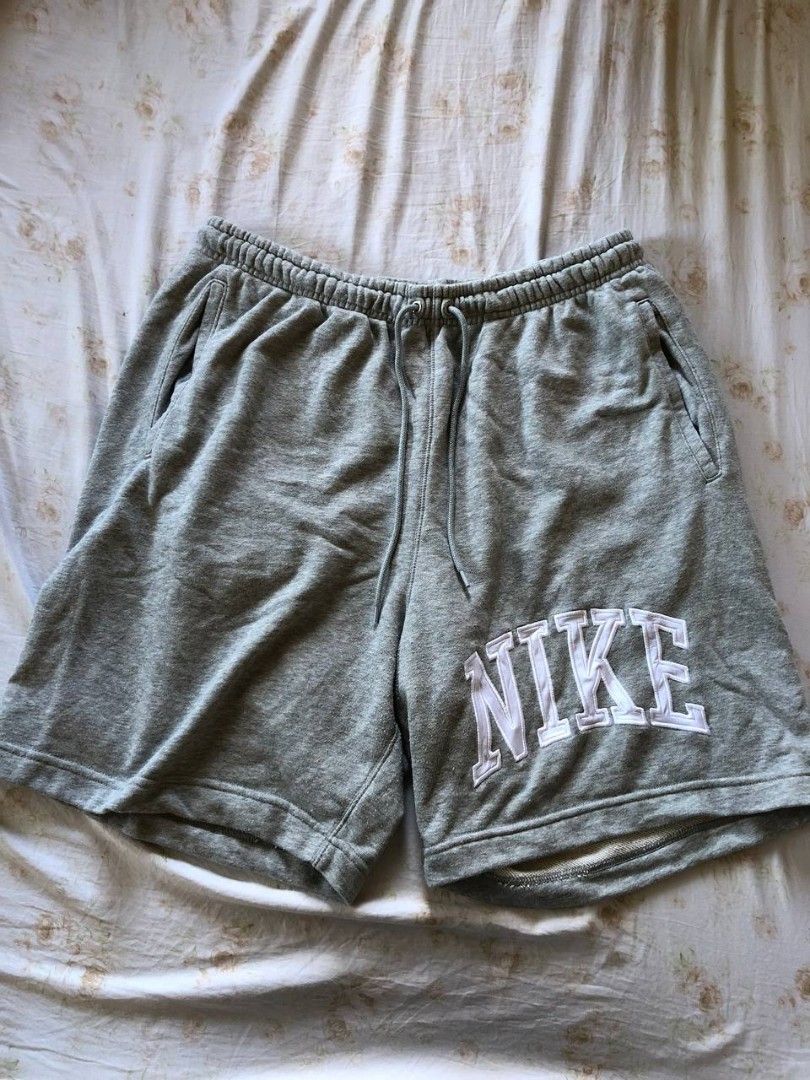 Nike french terry shorts (Category: Shorts) located in Romblon. Submitted by teppthrift. (Listing ID 1470422498, Image 1). Description: - Brand: Nike - Model: FQ4093-063 - Size: XXL - Color: Grey - Material: 80% cotton, 20% polyester fleece - Details: Thick embroidered Nike lettering on the left leg, elastic waistband with adjustable drawstrings - Pockets: Convenient side pockets plus one back pocket with a button closure - Fit: Relaxed fit, supe