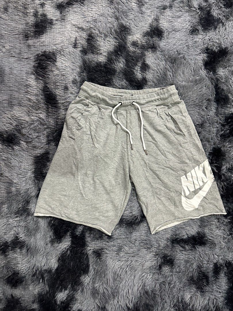Nike Grey Shorts with Large Logo Size S (Category: Shorts) located in Iba. Submitted by thriftcoyan (Listing ID 1470488689, Image 1). Description: - Brand: Nike - Size: Small - Color: Grey with large white swoosh logo on the left leg - Material: 100% cotton for maximum comfort - Waistband: Elastic with white drawstring and metal aglets - Pockets: Two functional side pockets - Hem: Stylish raw edge hem detail - Condition: Excellent / Pre-loved (re
