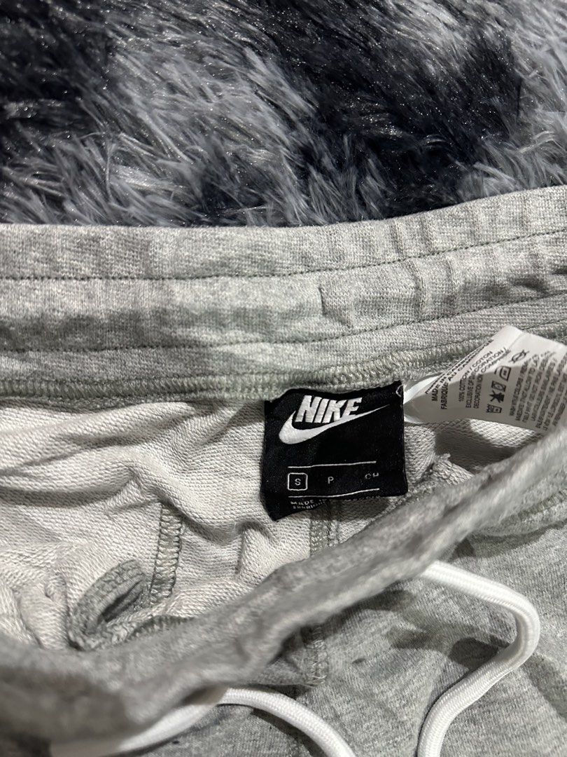 Nike Grey Shorts with Large Logo Size S (Category: Shorts) located in Iba. Submitted by thriftcoyan (Listing ID 1470488689, Image 3). Description: - Brand: Nike - Size: Small - Color: Grey with large white swoosh logo on the left leg - Material: 100% cotton for maximum comfort - Waistband: Elastic with white drawstring and metal aglets - Pockets: Two functional side pockets - Hem: Stylish raw edge hem detail - Condition: Excellent / Pre-loved (re