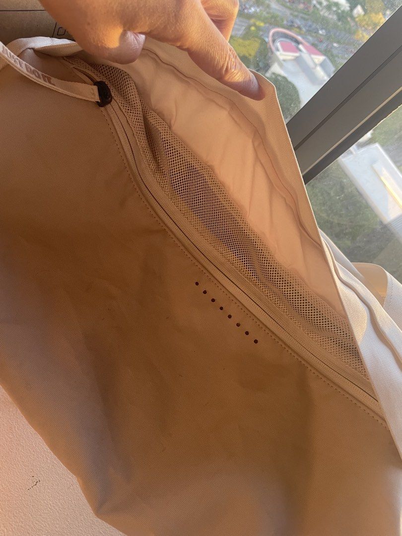 Nike Gym Bag (Category: Shoulder Bags) located in Muntinlupa City. Submitted by afs77 (Listing ID 1470440764, Image 3). Description: - Brand: Nike - Color: Off-white and cream - Features: Dual shoulder straps, secure zipper closure, interior zippered mesh pocket, and ventilation eyelets - Condition: Spacious capacity with visible wear on zipper pull tabs and some dirt marks on the fabric Location: Filinvest City/Alabang.
