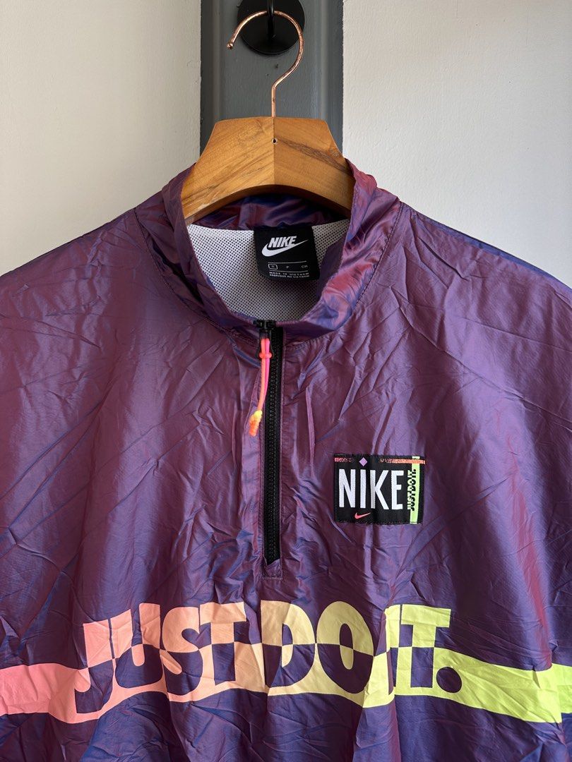 Nike Just Do It Iridescent Half-Zip Windbreaker Jacket Size S (Category: Coats, Jackets and Outerwear) located in Bacolod City. Submitted by thestitchph (Listing ID 1470470024, Image 3). Description: - Brand: Nike - Style: Half-zip windbreaker in a stunning purple iridescent fabric - Design: Large Just Do It graphic on the chest with vibrant pink and neon yellow accents - Features: Stand-up collar with zip closure, breathable white mesh lining, a