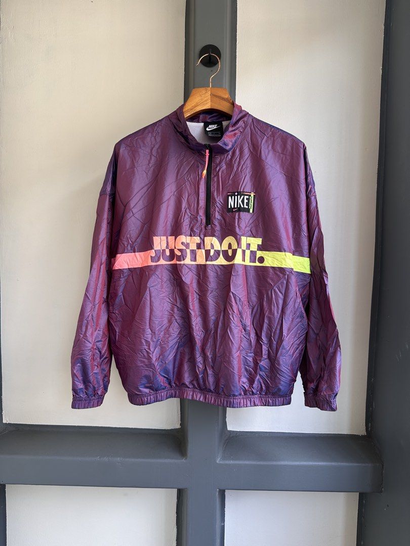 Nike Just Do It Iridescent Half-Zip Windbreaker Jacket Size S (Category: Coats, Jackets and Outerwear) located in Bacolod City. Submitted by thestitchph (Listing ID 1470470024, Image 2). Description: - Brand: Nike - Style: Half-zip windbreaker in a stunning purple iridescent fabric - Design: Large Just Do It graphic on the chest with vibrant pink and neon yellow accents - Features: Stand-up collar with zip closure, breathable white mesh lining, a