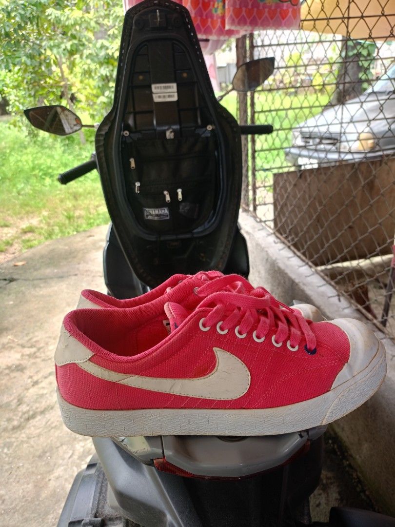 Nike Pink Canvas Low Top Sneakers (Category: Sneakers) located in Caloocan City. Submitted by reymartthrift (Listing ID 1470356347, Image 3). Description: - Brand/Model: Nike Canvas Low Tops - Color: Bright pink with white swoosh and rubber toe caps - Inclusions: Original white laces - Condition: Soles show wear, some dirt marks on white rubber bumpers and toe areas - Interior: Inside branding is very clean.