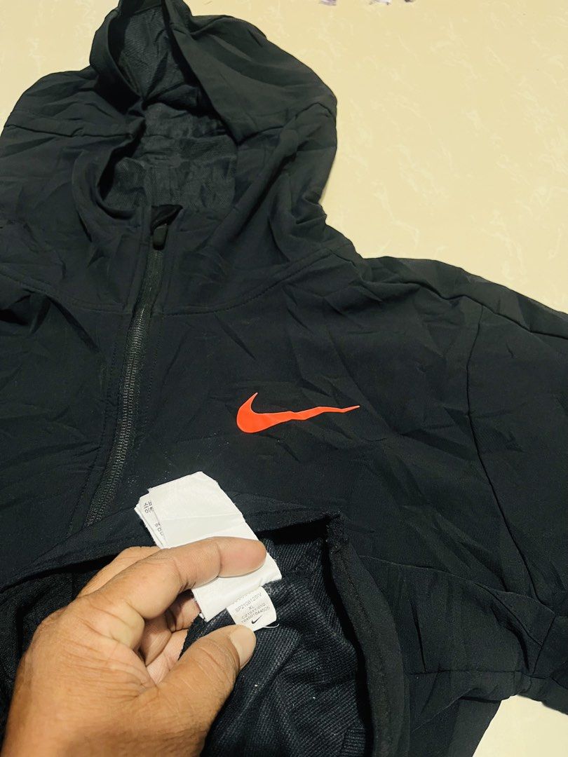 Nike Pro Black Half-Zip Packable Hoodie Jacket (Category: Coats, Jackets and Outerwear) located in Manila. Submitted by athan0800 (Listing ID 1470417212, Image 3). Description: - Brand: Nike Pro - Style: Half-zip hooded jacket with striking orange accents and sleeve branding - Size: XL (Standard fit) - Origin: Made in Vietnam - Features: Lightweight material, deep zipped front pockets, and built-in packable design for easy travel - Condition: Cle