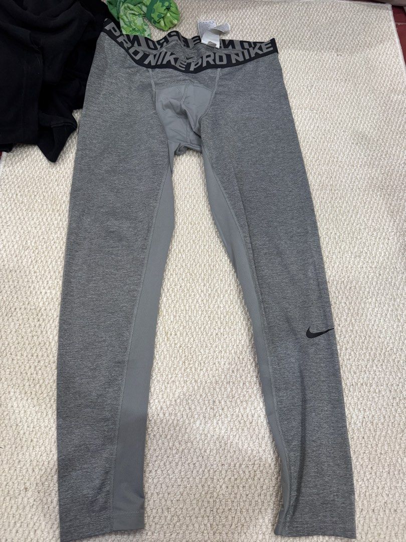 Nike Pro Grey Compression Leggings Tights (Category: Activewear) located in Valenzuela. Submitted by crabncorn (Listing ID 1470363585, Image 1). Description: - Brand: Nike Pro - Color: Grey with dark grey contrast side panels - Features: Branded elastic waistband, small Nike swoosh logo near lower left cuff - Condition: Brand new with tag attached at back waistline - Material: Stretchy and breathable fabric, perfect for workouts.