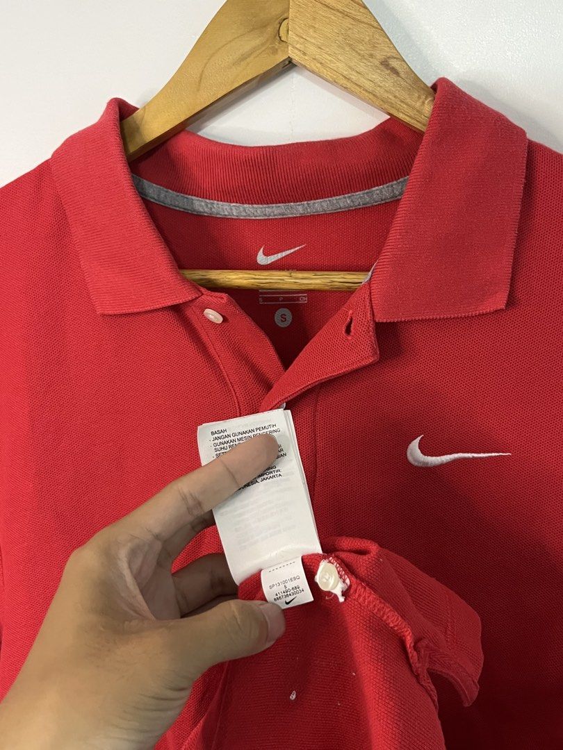 Nike Red Polo Shirt Size S (Category: Tshirts & Polo Shirts ) located in Dasmarinas. Submitted by thriftedbygii (Listing ID 1470532985, Image 3). Description: - Brand: Nike - Color: Red - Size: Small (S) - Material: Soft and breathable pique cotton - Design: Classic collar with two-button placket - Logo: Iconic embroidered white Swoosh on the chest - Condition: Clean, well-maintained, tag still intact inside the collar - Style: Great for daily we