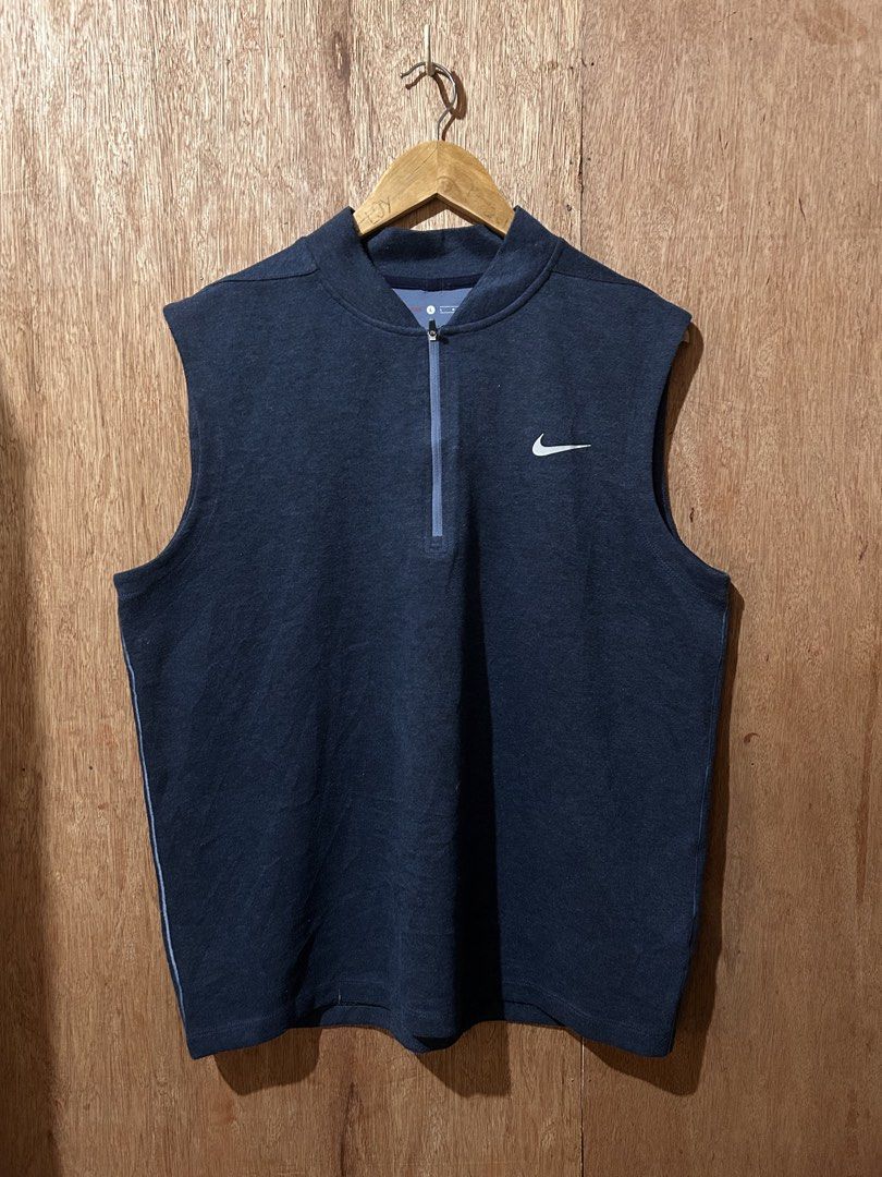 Nike Tiger Woods Collection Half Zip Golf Vest (Category: Vests) located in Cabiao. Submitted by alldaythrift (Listing ID 1470504308, Image 1). Description: - Brand: Nike (Tiger Woods Collection) - Item: Sleeveless half-zip vest / mock collar - Color: Navy blue with white Swoosh and TW logo - Size: Large - Material: Lightweight fabric with comfortable stretch - Condition: Excellent layering piece for golf or casual wear - Origin: Made in Thailand