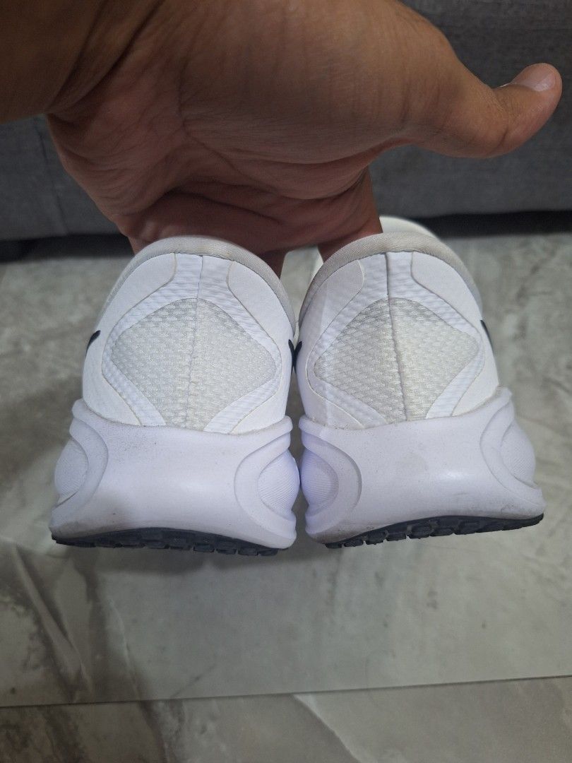 Nike White Slip-on Sneakers (Category: Sneakers) located in Manila. Submitted by slickeryslickslick (Listing ID 1470508833, Image 2). Description: - Material: Breathable mesh upper with a textured rubber outsole for reliable grip and take off for daily casual wear. - Condition: Normal yellowing staines due to long term storage..