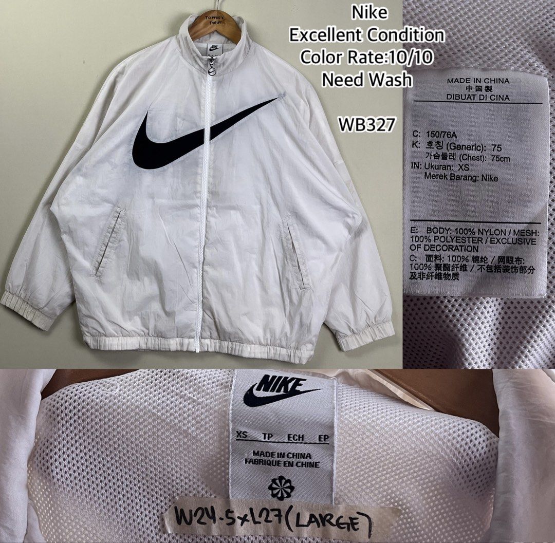 Nike White Windbreaker Jacket Oversized Swoosh (Category: Coats, Jackets and Outerwear) located in Malaybalay. Submitted by toffee_s_thrift0.1 (Listing ID 1470517663, Image 1). Description: - Brand: Nike - Style: Windbreaker with large black swoosh on front, full zip closure, and side pockets - Color: White with black branding - Size: Tagged XS, but fits like a Large (Actual measurements: Width 24.5" x Length 27") - Materials: 100% nylon body, 10