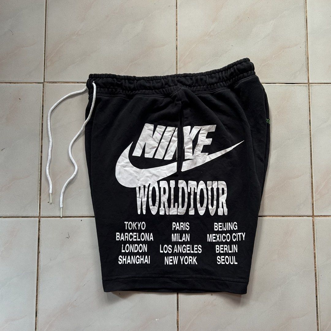 Nike World Tour Black short 🔥 (Category: Shorts) located in Jinoba-an. Submitted by eegiboy (Listing ID 1470397735, Image 3). Description: - Brand/Model: Nike World Tour Black Fleece Shorts - Size: Large (L) - Design: Bold white logo & city names on left leg, orange spray-paint smiley swoosh on right leg, and small green 'Beaverton, Oregon' text under the back pocket - Features: Adjustable drawstring waistband, convenient side pockets, and one b