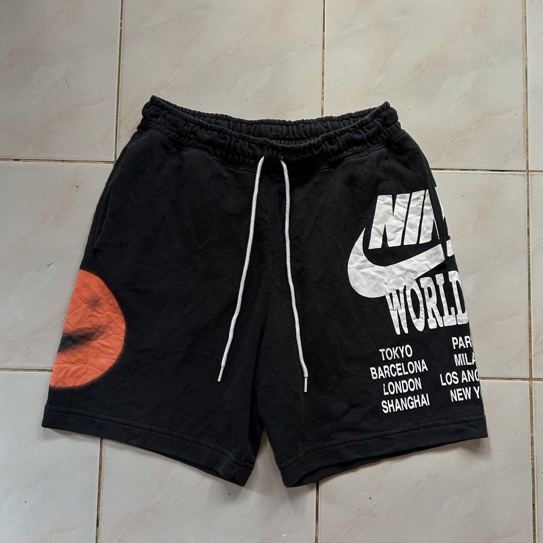 Nike World Tour Black short 🔥 (Category: Shorts) located in Jinoba-an. Submitted by eegiboy (Listing ID 1470397735, Image 1). Description: - Brand/Model: Nike World Tour Black Fleece Shorts - Size: Large (L) - Design: Bold white logo & city names on left leg, orange spray-paint smiley swoosh on right leg, and small green 'Beaverton, Oregon' text under the back pocket - Features: Adjustable drawstring waistband, convenient side pockets, and one b