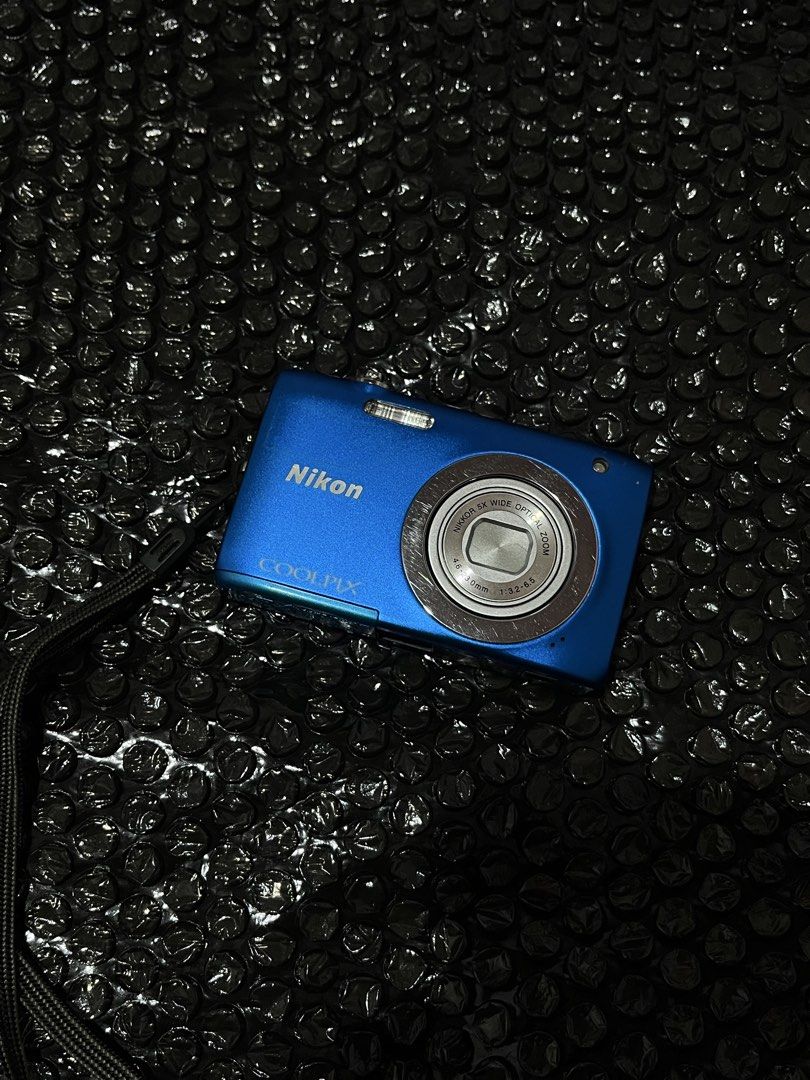 Nikon Coolpix S2600 (Category: Cameras) located in Manila. Submitted by r_zlxa (Listing ID 1470440710, Image 1). Description: - Model: Nikon Coolpix S2600 Compact Digital Camera - Color: Vibrant Blue - Lens: 5x optical zoom (4.6-23mm, f/3.2-6.5) - Features: Built-in flash, rear LCD screen with standard navigation buttons, and powers on via top button - Portability: Pocket-sized and lightweight, includes attached wrist strap - Ideal For: Daily sna