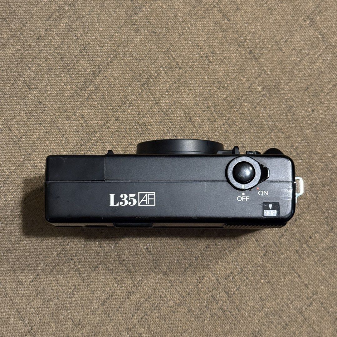 Nikon L35AF 35mm Film Camera (Pikaichi) (Category: Cameras) located in Las Pinas. Submitted by rtmrz (Listing ID 1470479213, Image 3). Description: Nikon L35AF 35mm Film Camera (ISO 400) Recently CLA’d and fully working. The battery door is a little loose but still closes properly. It just needs careful handling. Inclusions: * Camera strap * Energizer Original AA/AAA Battery Charger * 4 rechargeable AA batteries (1.2V, 2450mAh) RFS: No longer usi