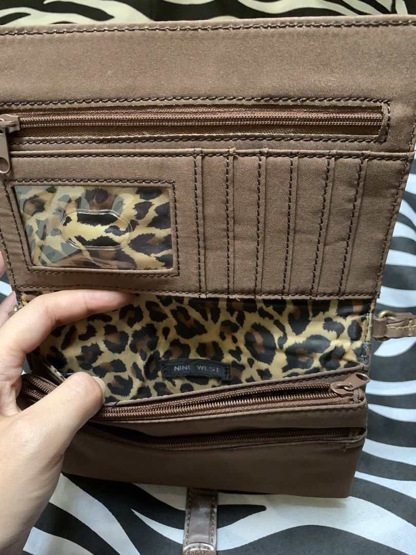 Nine West Brown Wallet Shoulder Bag (Category: Shoulder Bags) located in Manila. Submitted by usagichan_rabbit (Listing ID 1470385678, Image 2). Description: - Brand: Nine West - Material: Brown faux leather with chic crocodile embossing - Closure: Flap front with snap button strap detail - Interior: Trendy leopard print fabric lining - Organization: Built-in multiple card slots, clear ID window, and secure zippered compartments inside and out - 