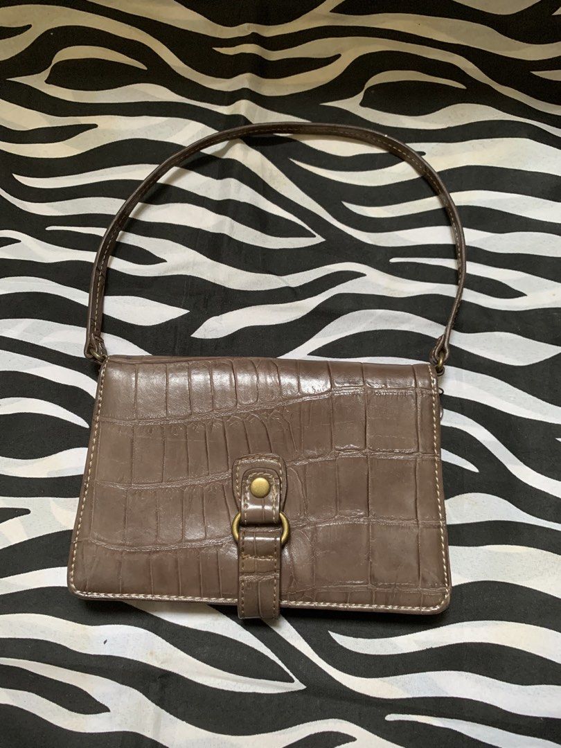 Nine West Brown Wallet Shoulder Bag (Category: Shoulder Bags) located in Manila. Submitted by usagichan_rabbit (Listing ID 1470385678, Image 1). Description: - Brand: Nine West - Material: Brown faux leather with chic crocodile embossing - Closure: Flap front with snap button strap detail - Interior: Trendy leopard print fabric lining - Organization: Built-in multiple card slots, clear ID window, and secure zippered compartments inside and out - 