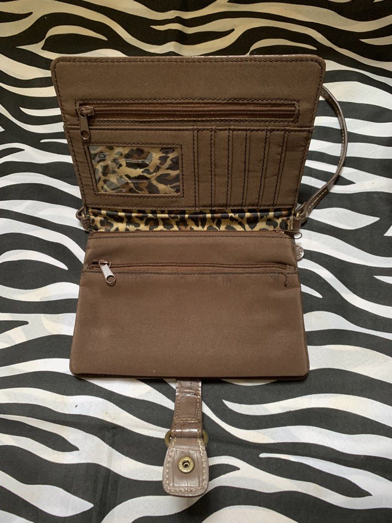 Nine West Brown Wallet Shoulder Bag (Category: Shoulder Bags) located in Manila. Submitted by usagichan_rabbit (Listing ID 1470385678, Image 3). Description: - Brand: Nine West - Material: Brown faux leather with chic crocodile embossing - Closure: Flap front with snap button strap detail - Interior: Trendy leopard print fabric lining - Organization: Built-in multiple card slots, clear ID window, and secure zippered compartments inside and out - 