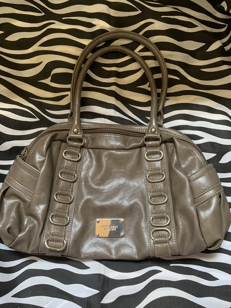 Nine west vintage bag (Category: Luxury Bags & Wallets) located in Manila. Submitted by usagichan_rabbit (Listing ID 1470362870, Image 1). Description: - Brand: Nine West - Color: Greyish taupe (neutral tone that matches any outfit) - Hardware: Silver with stylish vertical ring details on the front - Closure: Secure zip top closure - Interior: Cream fabric lining with a convenient zipper pocket - Capacity: Roomy main compartment for all your dail