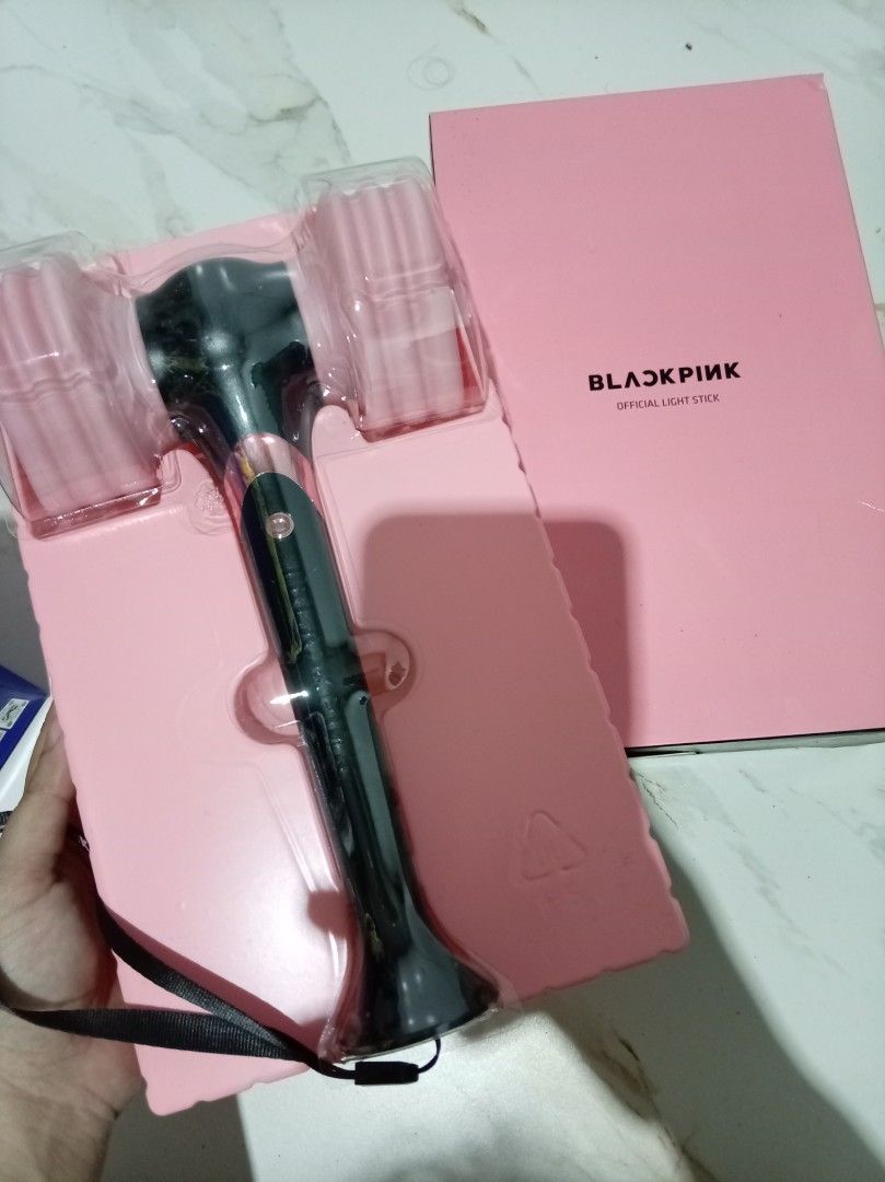 Official BLACKPINK Light Stick with Pink Box (Category: K-Wave Merchandise) located in Manila. Submitted by zeepheobee (Listing ID 1470436212, Image 1). Description: - Official BLACKPINK light stick - Includes original pink box and molded plastic insert packaging - Features iconic black handle and pink hammer heads - Comes with attached wrist strap at the bottom - Fully functional, perfect for concerts or fan collections - Stored carefully inside