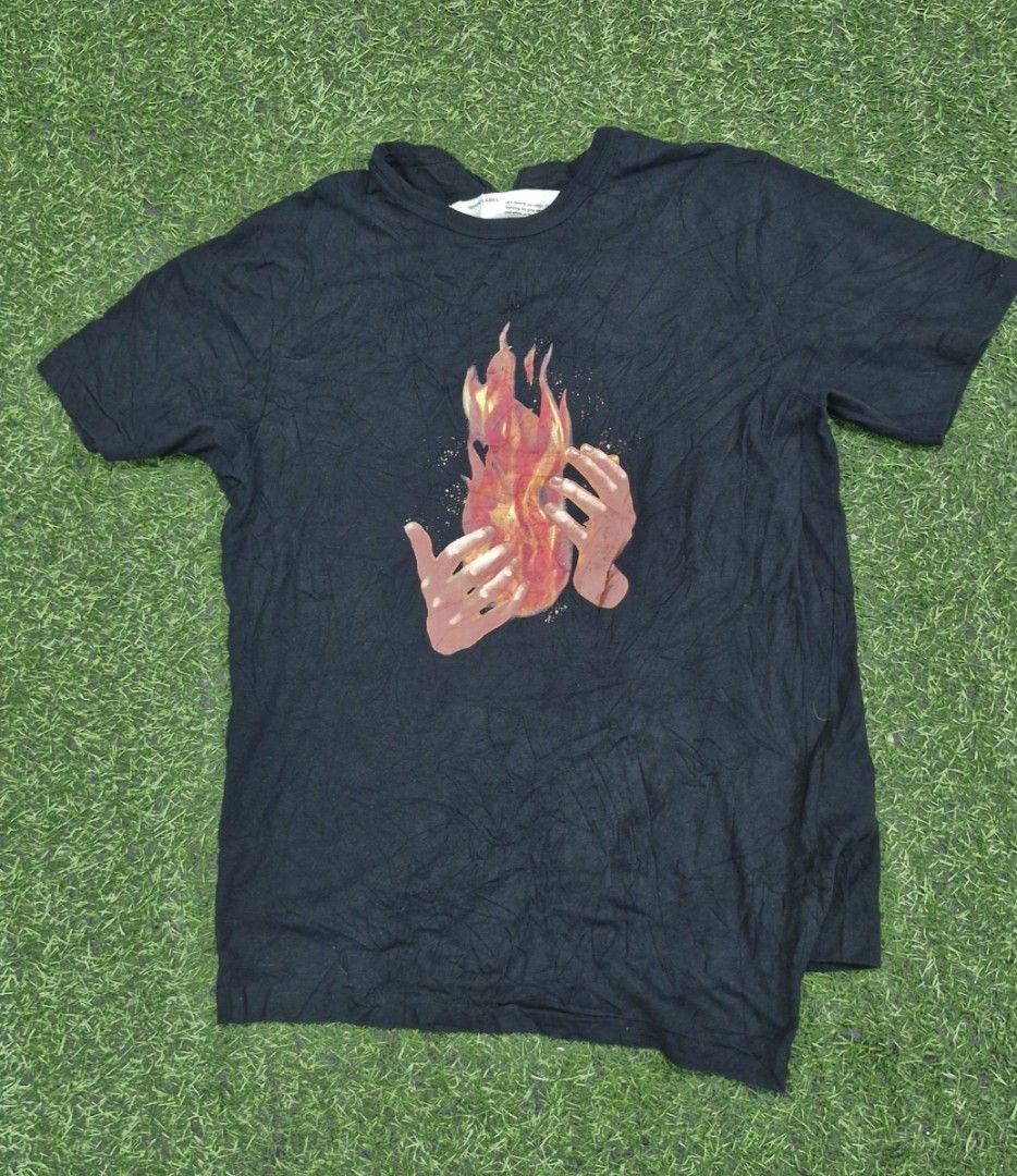 Off-White Black Flames In Hands T-Shirt (Category: Tshirts & Polo Shirts ) located in Pili. Submitted by the_g_thrift (Listing ID 1470468564, Image 1). Description: Off-White Black Flames In Hands T-Shirt size medium on tag dimes: 20 x 29 very good condition issue minimal na bakbak sa print dumikit kasi as as new sana single stitch.