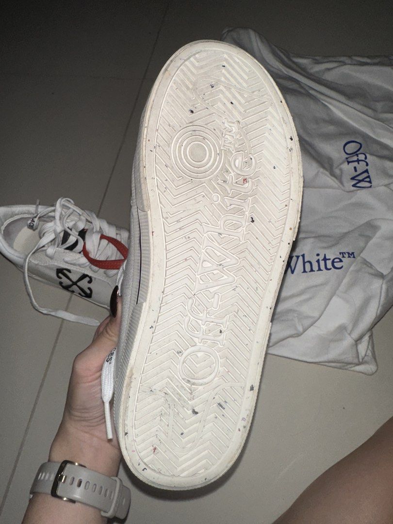 Off-White Low Top Canvas Sneakers (Category: Sneakers) located in Caloocan City. Submitted by ninarodriguez (Listing ID 1470488895, Image 3). Description: - Brand: Off-White - Style: White canvas low-top sneakers - Details: Black arrow embroidery, signature red zip-tie, 'SHOELACES' text on laces, and debossed outsole branding - Condition: Worn twice, soles show minor dirt from walking, can be cleaned - Inclusion: Comes with 2 white dust bag - Bou