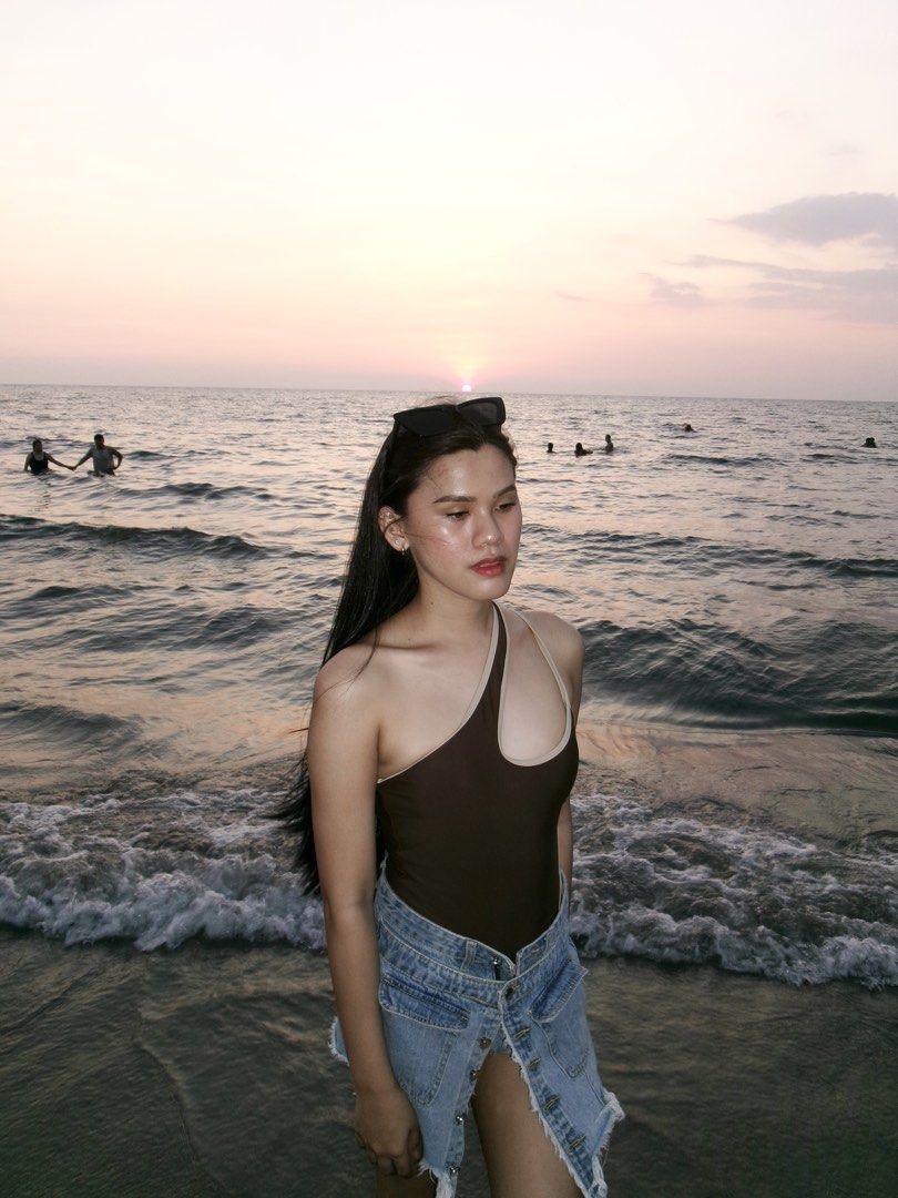 One-shoulder brown and beige swimsuit (Category: Bikinis & Swimsuits) located in Makati City. Submitted by lemoneyeddd (Listing ID 1470502201, Image 3). Description: - Style: One-piece swimsuit with an asymmetrical neckline - Details: Contrast beige trim on shoulder strap and cutout - Condition: Worn once for beach photos, freshly washed and clean - Styling Tip: Looks amazing paired with denim shorts - Perfect for: Beach trips, pool days, and vac