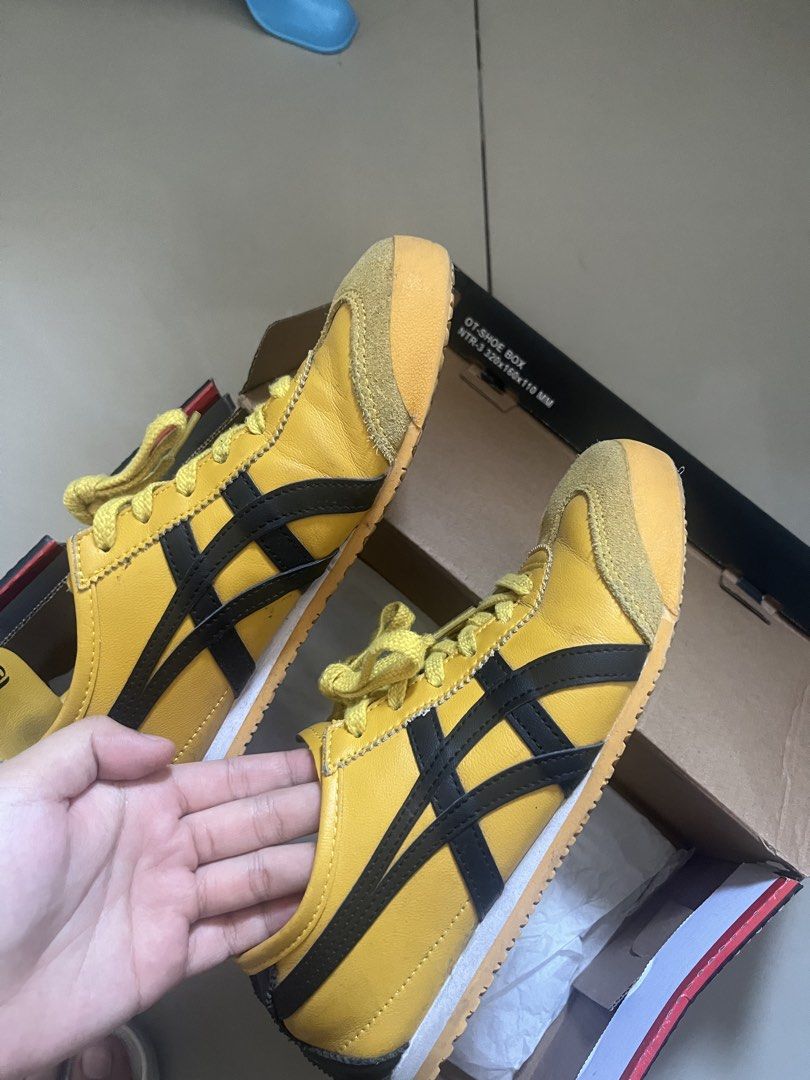 Onitsuka Tiger Yellow Black Sneakers with Box (Category: Sneakers) located in Manila. Submitted by dane.1018 (Listing ID 1470391663, Image 3). Description: - Brand: Onitsuka Tiger - Color: Iconic Yellow and Black - Style: Low-top sneakers - Details: Suede toe cap and heel counter - Comfort & Grip: Perforated insoles and textured rubber outsoles with great traction - Inclusions: Comes with original shoe box - Condition: Well-maintained and ready t