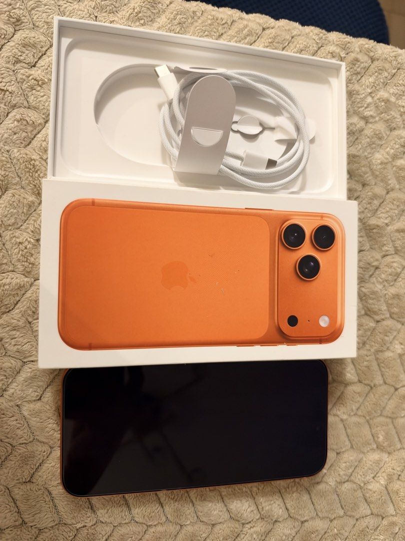 Orange iPhone (Category: iPhone 17 Series) located in Manila. Submitted by danny_dj (Listing ID 1470495430, Image 2). Description: - Color: Vibrant Orange - Camera: Triple camera setup on the back - Battery Health: 95% (282 cycle counts) - Condition: Clean and unmarked screen - Inclusions: Original box, charging cable, and SIM ejector pin - Meetup Bought in powermac RFS got new phone.