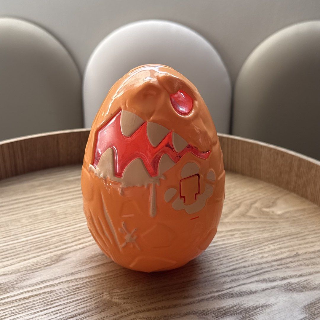 Orange Monster Dinosaur Egg Toy Container (Category: Kids Toys) located in Marikina City. Submitted by lovegoeson (Listing ID 1470535245, Image 1). Description: - Bright orange plastic monster egg container - Textured outer shell with fun molded teeth and eye details - Hinged design opens up to store small items, toys, or treats - Convenient round twist cover on the inside lid - Clean inside and out, ready for play.