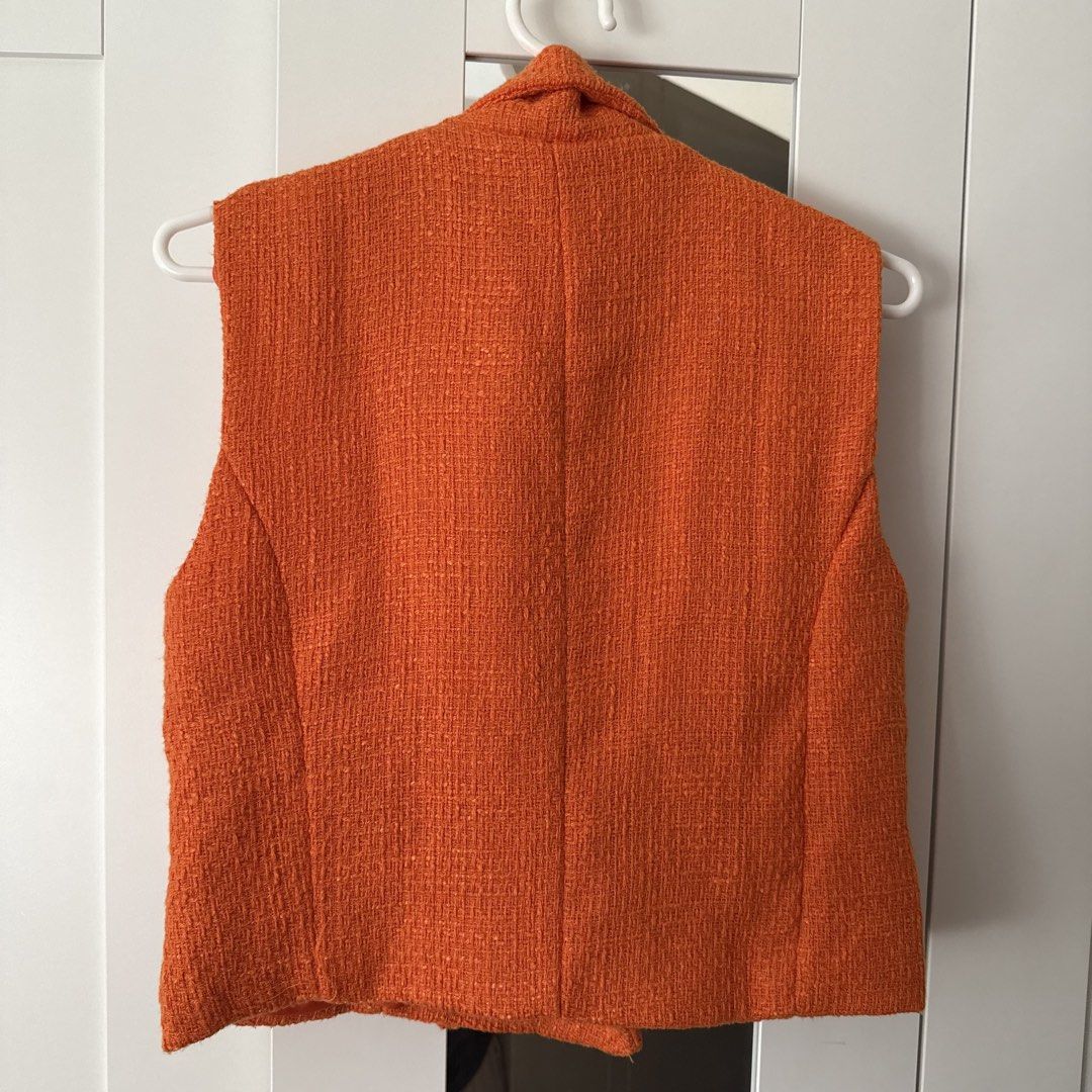 Orange tweed sleeveless vest jacket lined top (Category: Sleeveless) located in Marikina City. Submitted by lovegoeson (Listing ID 1470354786, Image 2). Description: - Color: Vibrant bright orange - Material: Textured tweed with matching silky full lining - Design: Sleeveless with a high neckline - Fit: Structured back with clean panel seams - Styling: Perfect layering piece for cooler weather.