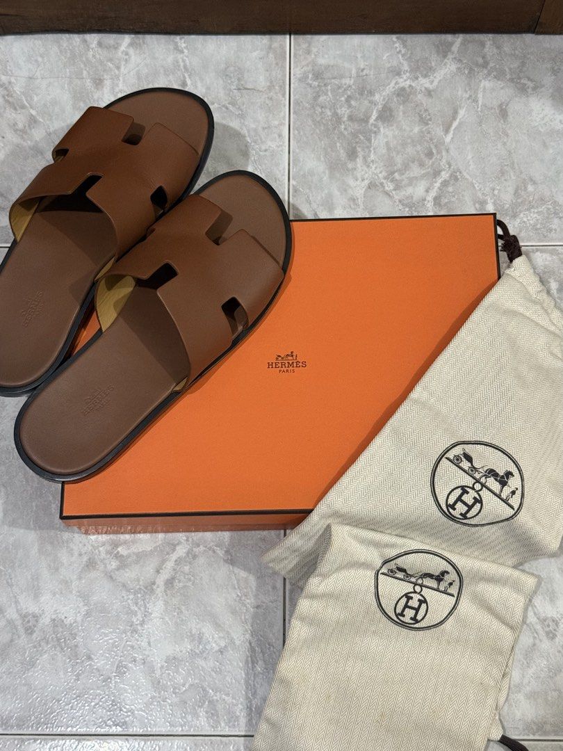 ORIGINAL Hermes Izmir Sandals (Category: Slippers & Slides) located in Quezon City. Submitted by ches.declutters (Listing ID 1470527822, Image 1). Description: - 100% AUTHENTIC - Bought in Singapore - Includes original Hermes box and dust bags - Condition: 9/10 - Minor scuffs and creases, which is expected especially for footwear.