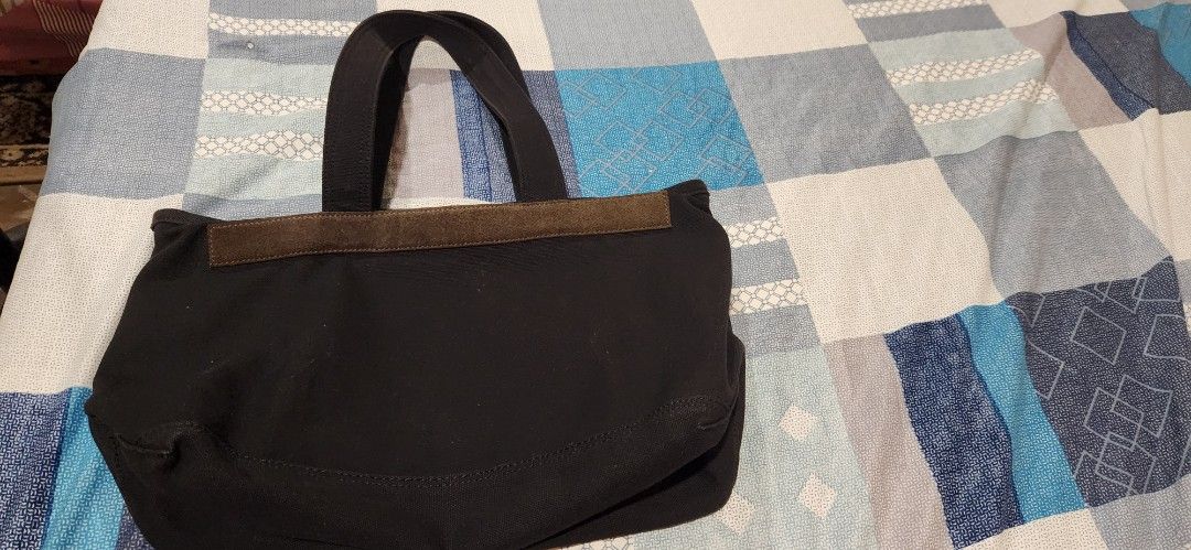 Original Marc Jacobs Black Canvas Tote Bag (Category: Tote Bags) located in Marikina City. Submitted by kath_08 (Listing ID 1470351194, Image 3). Description: - Brand: Marc Jacobs - Material: Durable black canvas with dark suede accent trim - Design: Bold stacked lettering print across the front - Closure: Secure top zipper with metallic snap buttons - Interior: Spacious black fabric lining with an open slip pocket - Inclusions: Comes with two wh