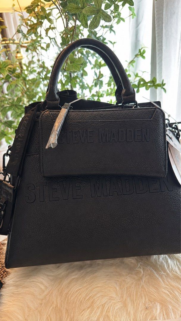 Original Steve Madden Black Bag with Pouch (Category: Tote Bags) located in Manila. Submitted by _itsmimi (Listing ID 1470487256, Image 1). Description: - Brand: Steve Madden - Material: Pebbled faux leather - Color: Black - Condition: Brand new with store tags attached - Features: Structured shape, textured finish, dual top handles, and a shoulder strap - Includes: Matching zippered pouch attached on the front with embossed brand logo.