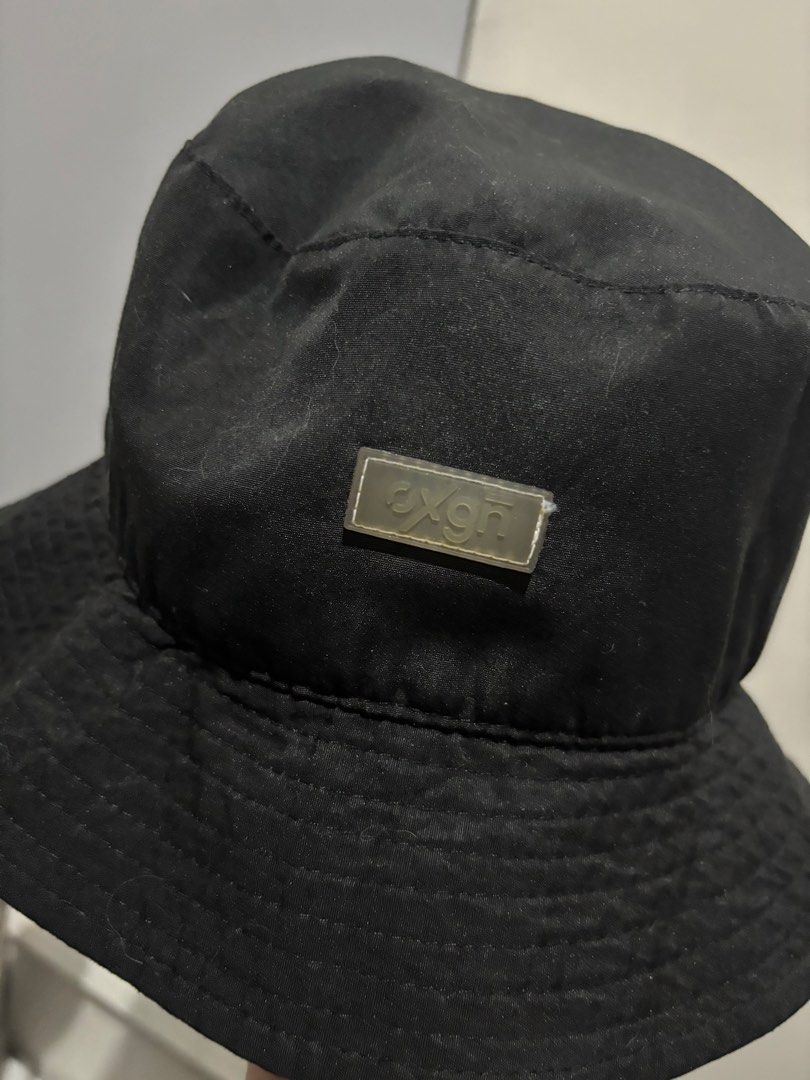 OXGN Black Bucket Hat One Size (Category: Caps & Hats) located in Manila. Submitted by aysshxx (Listing ID 1470475877, Image 2). Description: - Brand: OXGN - Color: Solid black with a grey front logo patch - Size: One size fits all - Material: Clean and well-maintained basic streetwear accessory - Origin: Made in the Philippines - Care Instructions: Hand wash only, tumble dry low, hang to dry, do not iron.