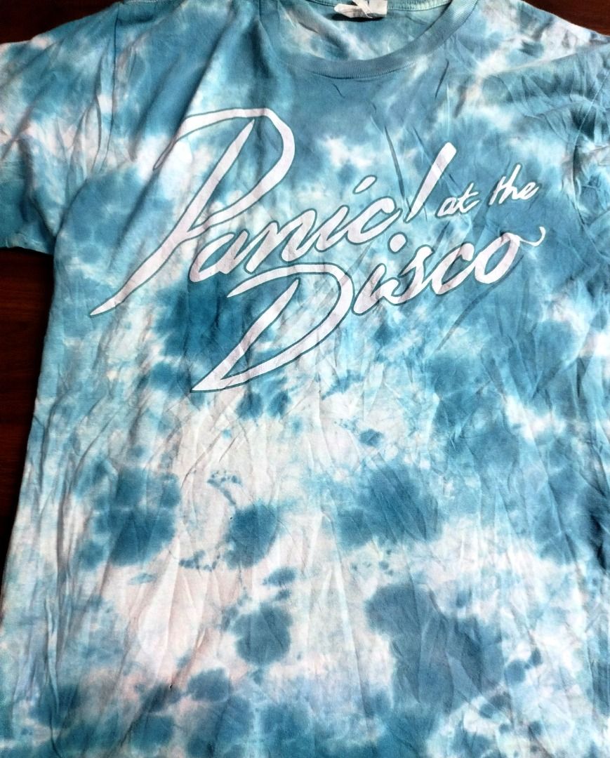 Panic! At The Disco Tie-Dye T-Shirt (Category: Tshirts & Polo Shirts ) located in Caloocan City. Submitted by safebear_4bdc70 (Listing ID 1470454610, Image 1). Description: Blue and white tie-dye t-shirt from Panic! At The Disco. Large white script logo across the front chest. Short sleeves, crew neck. Soft cotton material, relaxed fit. Great piece for band merch fans..