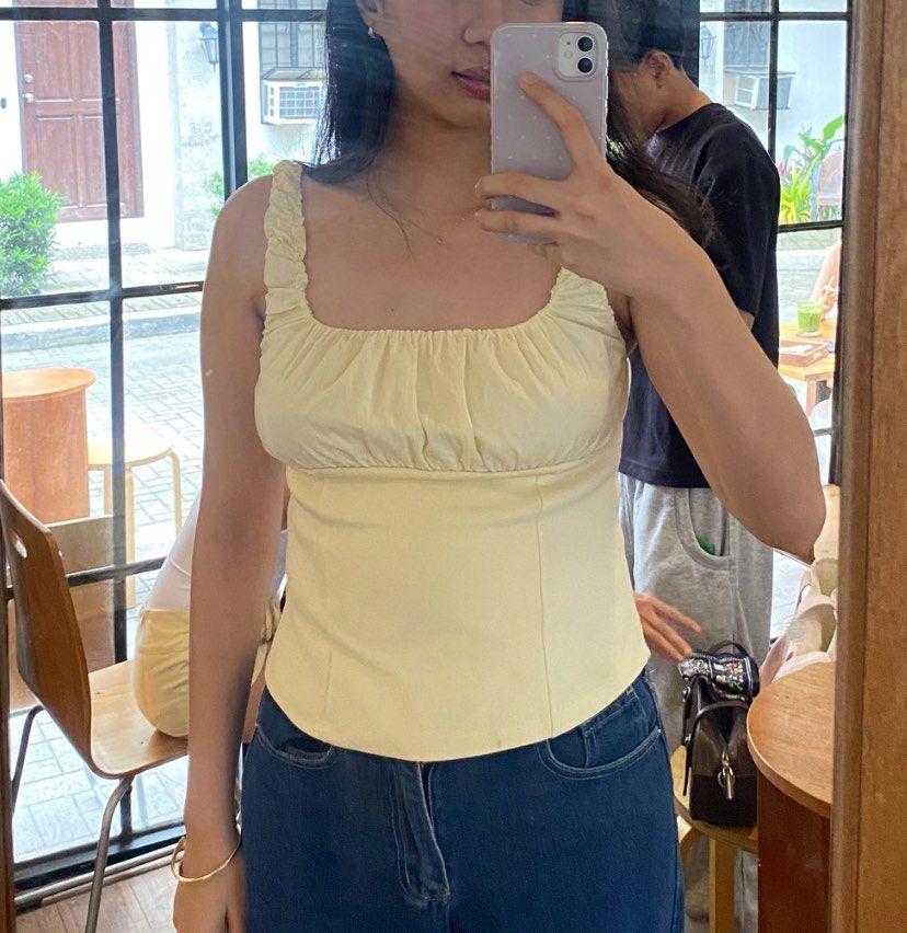 Pastel Yellow Ruched Straps Corset Style Top (Category: Sleeveless) located in Bacolor. Submitted by mxspicychicken (Listing ID 1470369767, Image 1). Description: Worn once Jnt pampanga - Color: Pastel yellow - Style: Sleeveless top with square neckline and gathered chest ruching - Details: Thick ruched straps, panel seams, curved hemline below the waist - Condition: Worn once, part of a closet cleanout - Pairing: Easy to match with high-waisted 