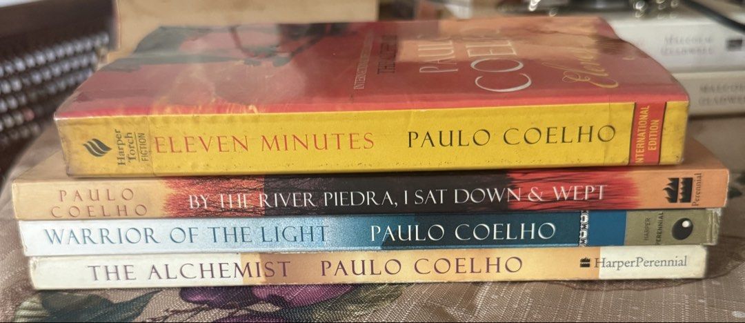 Paulo Coelho Book Bundle - 4 Novels (Category: Storybooks) located in Paranaque City. Submitted by jiggybautista (Listing ID 1470368144, Image 3). Description: - Bundle of 4 Paulo Coelho bestselling novels - Titles included: The Alchemist, Warrior of the Light, By the River Piedra I Sat Down & Wept, and Eleven Minutes - Format: Paperback (HarperPerennial & Harper Torch Fiction) - Condition: Pages have yellowing from age/storage; covers have minor