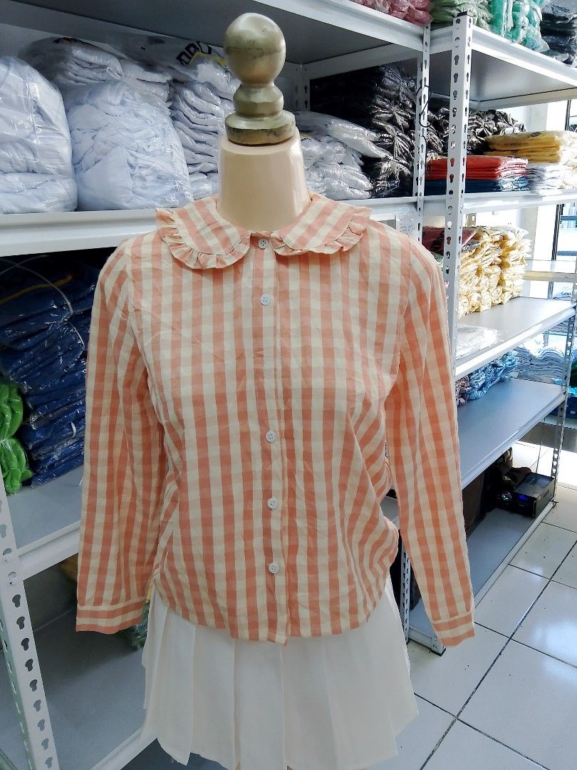 Peach and White Gingham Ruffle Collar Blouse (Category: Blouses) located in Midsayap. Submitted by jarethshop (Listing ID 1470432108, Image 1). Description: - Peach and white checkered long sleeve button-up shirt - Cute ruffled peter pan collar design - White front buttons and standard button cuffs - Lightweight fabric, perfect for layering.