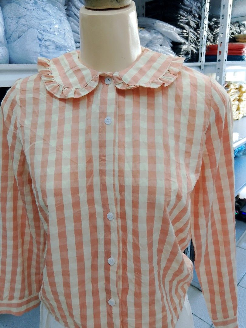 Peach and White Gingham Ruffle Collar Blouse (Category: Blouses) located in Midsayap. Submitted by jarethshop (Listing ID 1470432108, Image 2). Description: - Peach and white checkered long sleeve button-up shirt - Cute ruffled peter pan collar design - White front buttons and standard button cuffs - Lightweight fabric, perfect for layering.