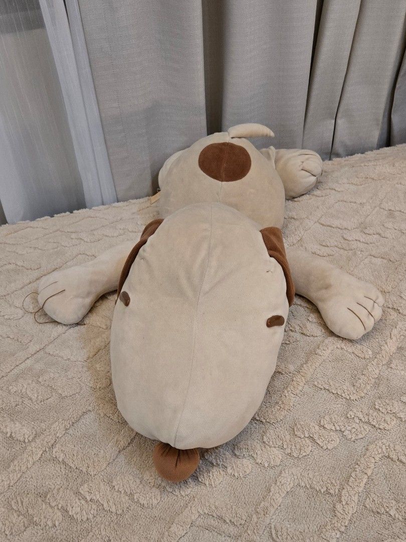 Peanuts Snoopy plush toy lying down soft doll (Category: Plushies & Soft Toys) located in Bulacan. Submitted by matchiii (Listing ID 1470510301, Image 2). Description: Large Snoopy plush toy from Peanuts. Lying down posture with soft beige body, brown ears, and spot on the back. Red collar around the neck. One paw has a loose thread on the embroidered claw detail, visible in photos. Tag still attached to the side..
