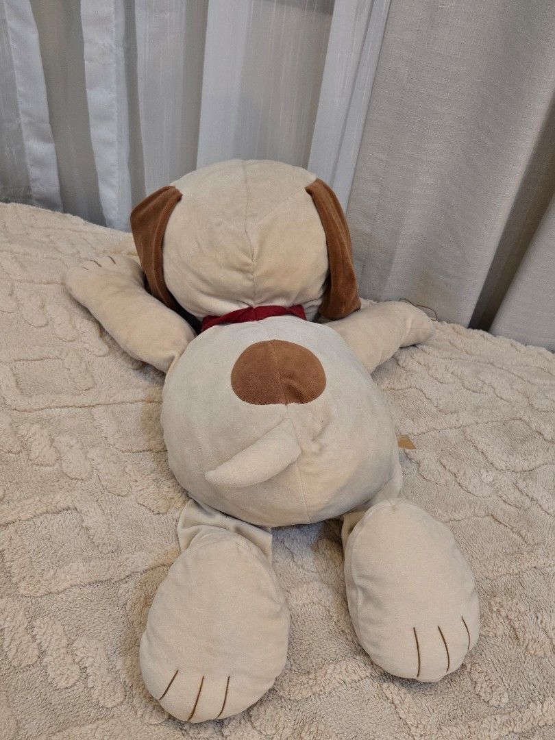Peanuts Snoopy plush toy lying down soft doll (Category: Plushies & Soft Toys) located in Bulacan. Submitted by matchiii (Listing ID 1470510301, Image 3). Description: Large Snoopy plush toy from Peanuts. Lying down posture with soft beige body, brown ears, and spot on the back. Red collar around the neck. One paw has a loose thread on the embroidered claw detail, visible in photos. Tag still attached to the side..