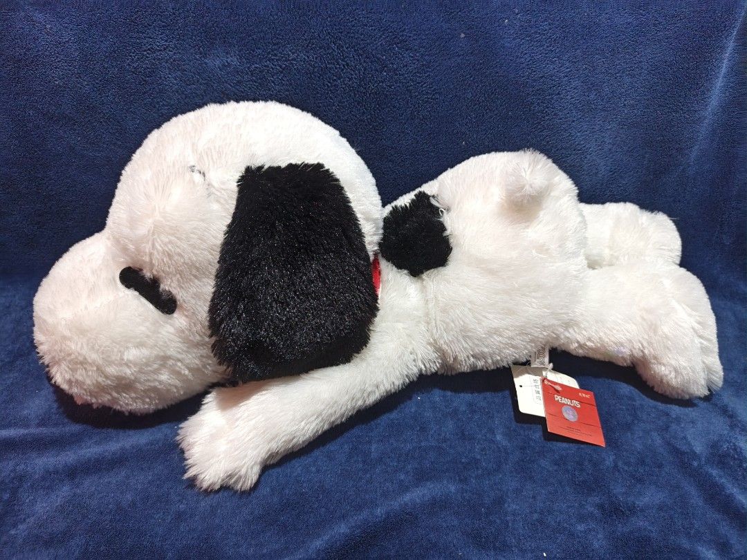 Peanuts Snoopy plush toy stuffed animal (Category: Plushies & Soft Toys) located in Manila. Submitted by kirstentoyshub (Listing ID 1470379893, Image 1). Description: - Official Peanuts Snoopy plush toy in large, huggable size - Super soft white fur with classic black ears, nose, and back patch - Comes with a cute red collar and original tags still attached - Ideal for collectors or as a gift for Snoopy fans of all ages.
