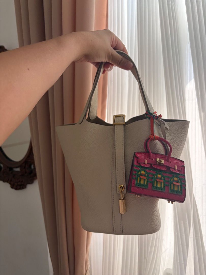 Picotin 18 Lock Nata Leather Bag (Category: Tote Bags) located in Quezon City. Submitted by missclutterfree (Listing ID 1470402202, Image 2). Description: - Pebble leather in color Nata with gold hardware - Made with premium quality leather - Bucket tote with padlock closure (includes keys and clochette) - Clean interior with a structured base - No major flaws and rubs. Hairline scratches are barely noticeable - FREE drawstring inner pouch and a 