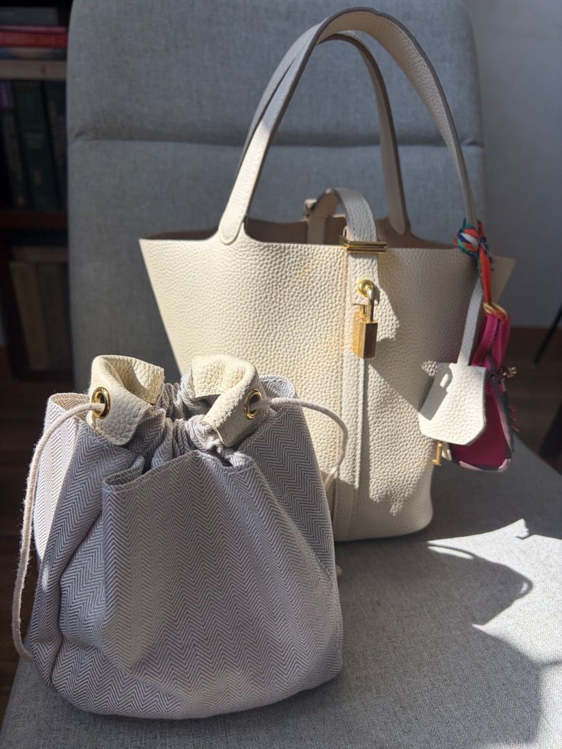 Picotin 18 Lock Nata Leather Bag (Category: Tote Bags) located in Quezon City. Submitted by missclutterfree (Listing ID 1470402202, Image 3). Description: - Pebble leather in color Nata with gold hardware - Made with premium quality leather - Bucket tote with padlock closure (includes keys and clochette) - Clean interior with a structured base - No major flaws and rubs. Hairline scratches are barely noticeable - FREE drawstring inner pouch and a 
