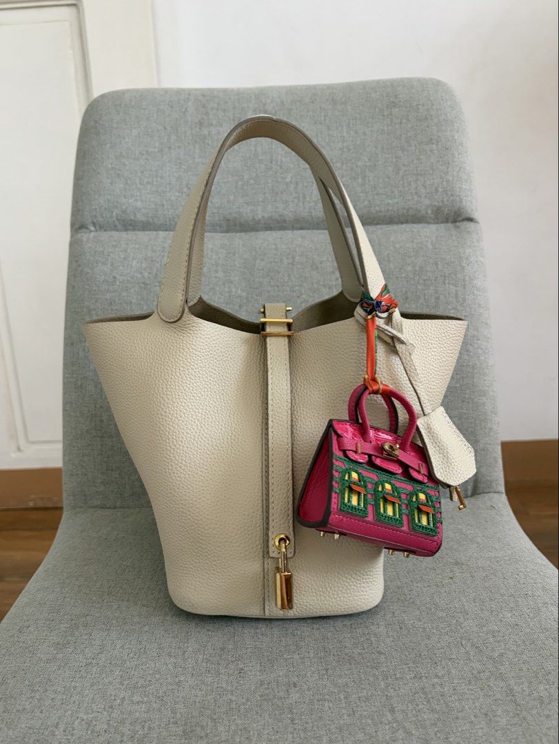 Picotin 18 Lock Nata Leather Bag (Category: Tote Bags) located in Quezon City. Submitted by missclutterfree (Listing ID 1470402202, Image 1). Description: - Pebble leather in color Nata with gold hardware - Made with premium quality leather - Bucket tote with padlock closure (includes keys and clochette) - Clean interior with a structured base - No major flaws and rubs. Hairline scratches are barely noticeable - FREE drawstring inner pouch and a 
