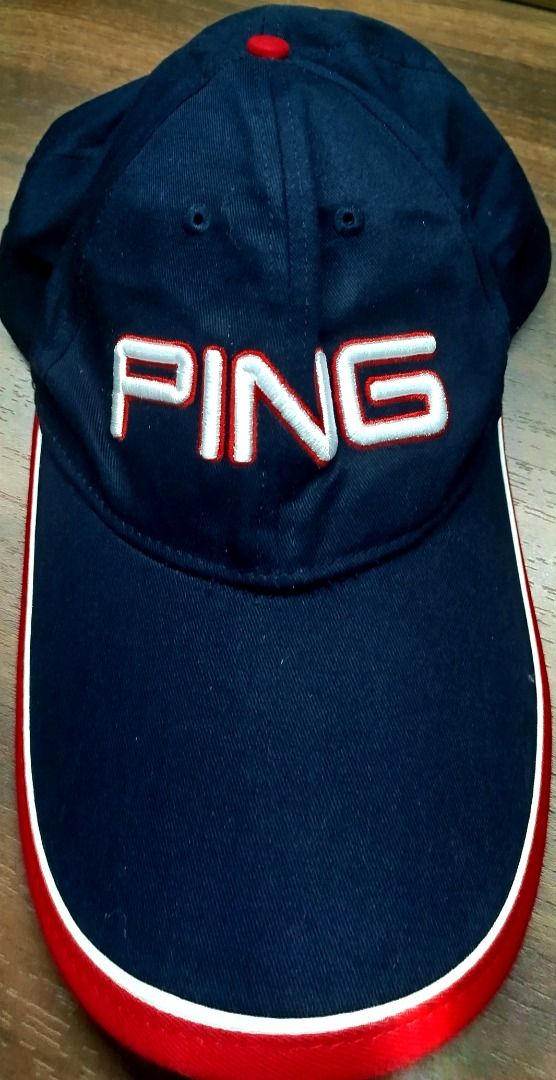 Ping Golf Cap Navy Blue Red White Adjustable (Category: Caps & Hats) located in Caloocan City. Submitted by safebear_4bdc70 (Listing ID 1470453390, Image 1). Description: Navy blue Ping cap with embroidered white and red logo on the front. Brim has red trim with a white accent piping line. Adjustable metal buckle strap at the back featuring the Ping logo engraved on the clasp. Red top button..