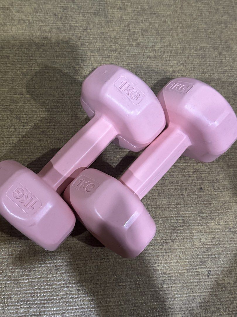 Pink 1kg dumbbells set of two weights (Category: Weights & Dumbbells) located in Pasig City. Submitted by rodzrox (Listing ID 1470510421, Image 1). Description: - Pair of pink dumbbells, 1kg each - Non-slip neoprene coating for a secure grip - Compact size, easy to store under the bed or in corners - Ideal for home fitness, arm toning, or light physical therapy - Note: Minor scuffs on the coating from standard storage.